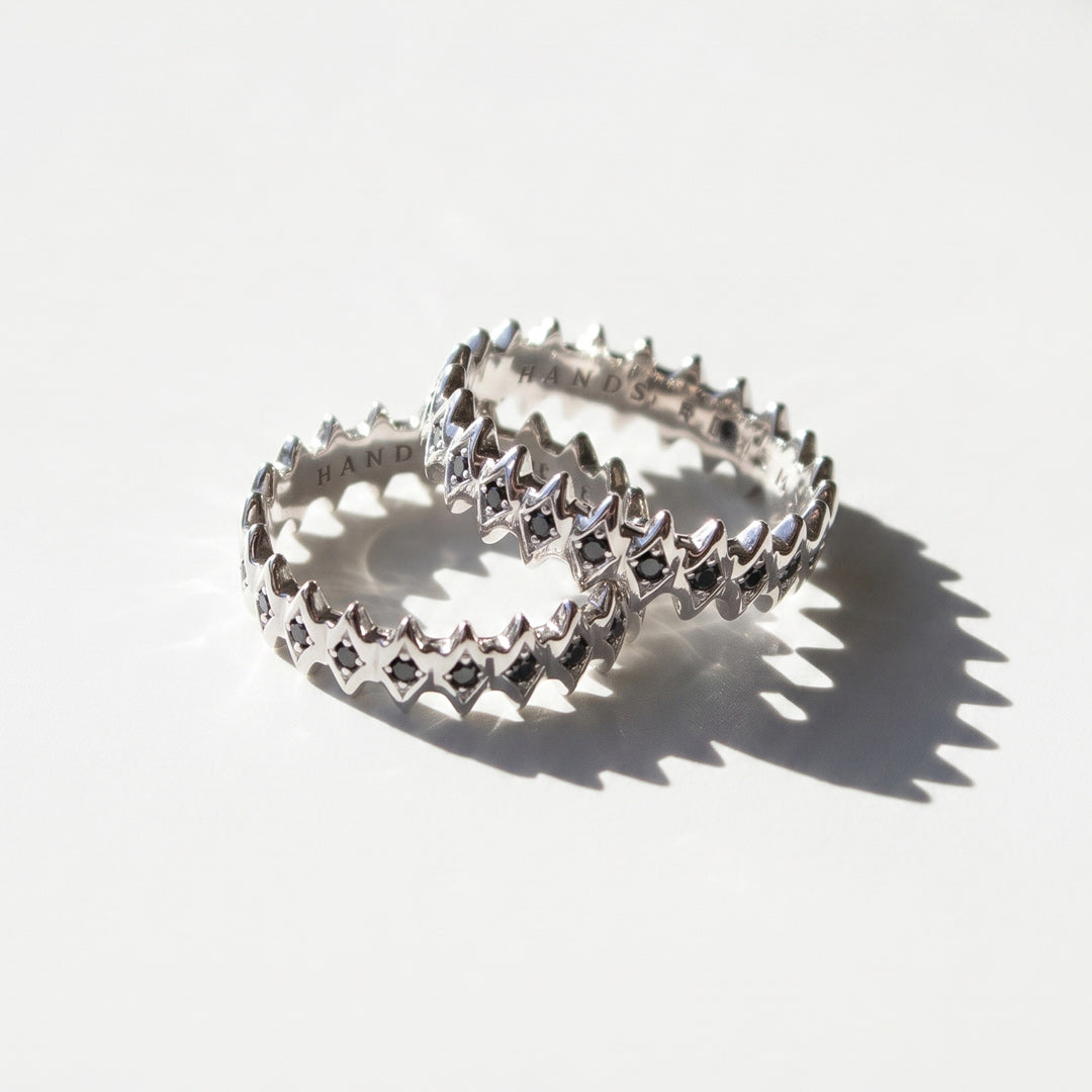 White gold rings with black diamonds on a white background