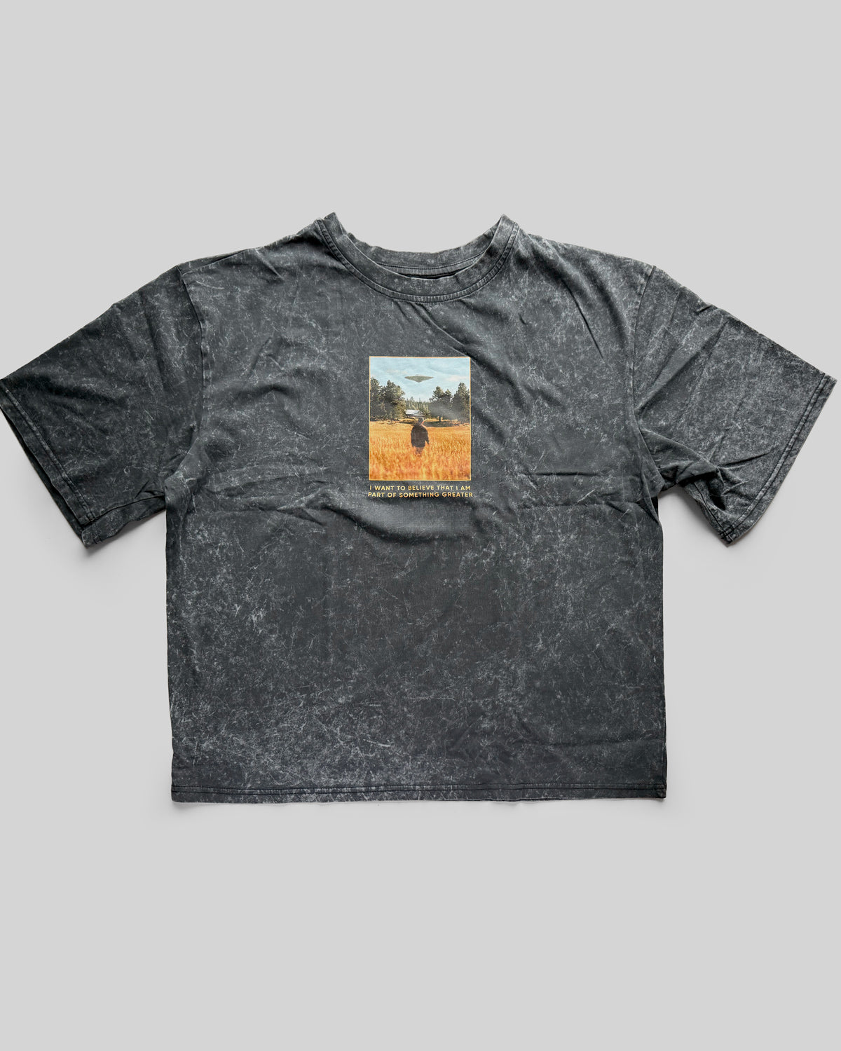 Gray t-shirt with a graphic print on a gray background
