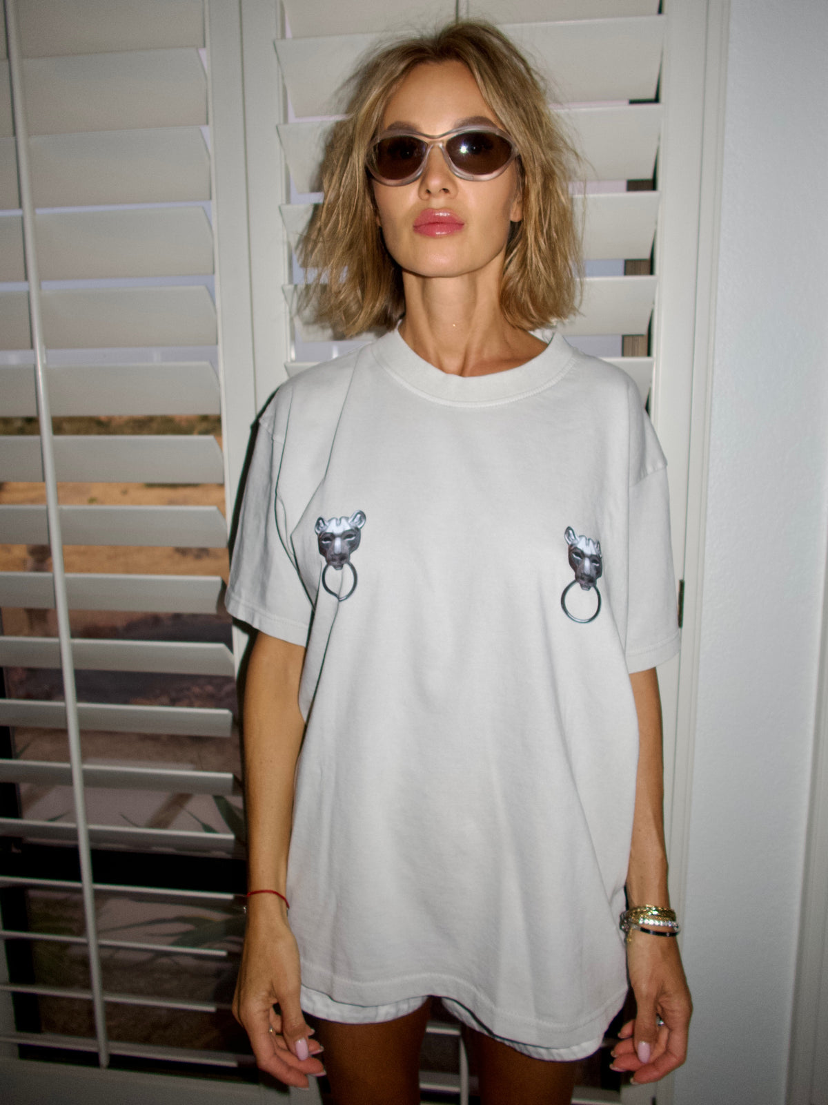 Light grey T-shirt with twin puma graphics and ring details, portrait front view.