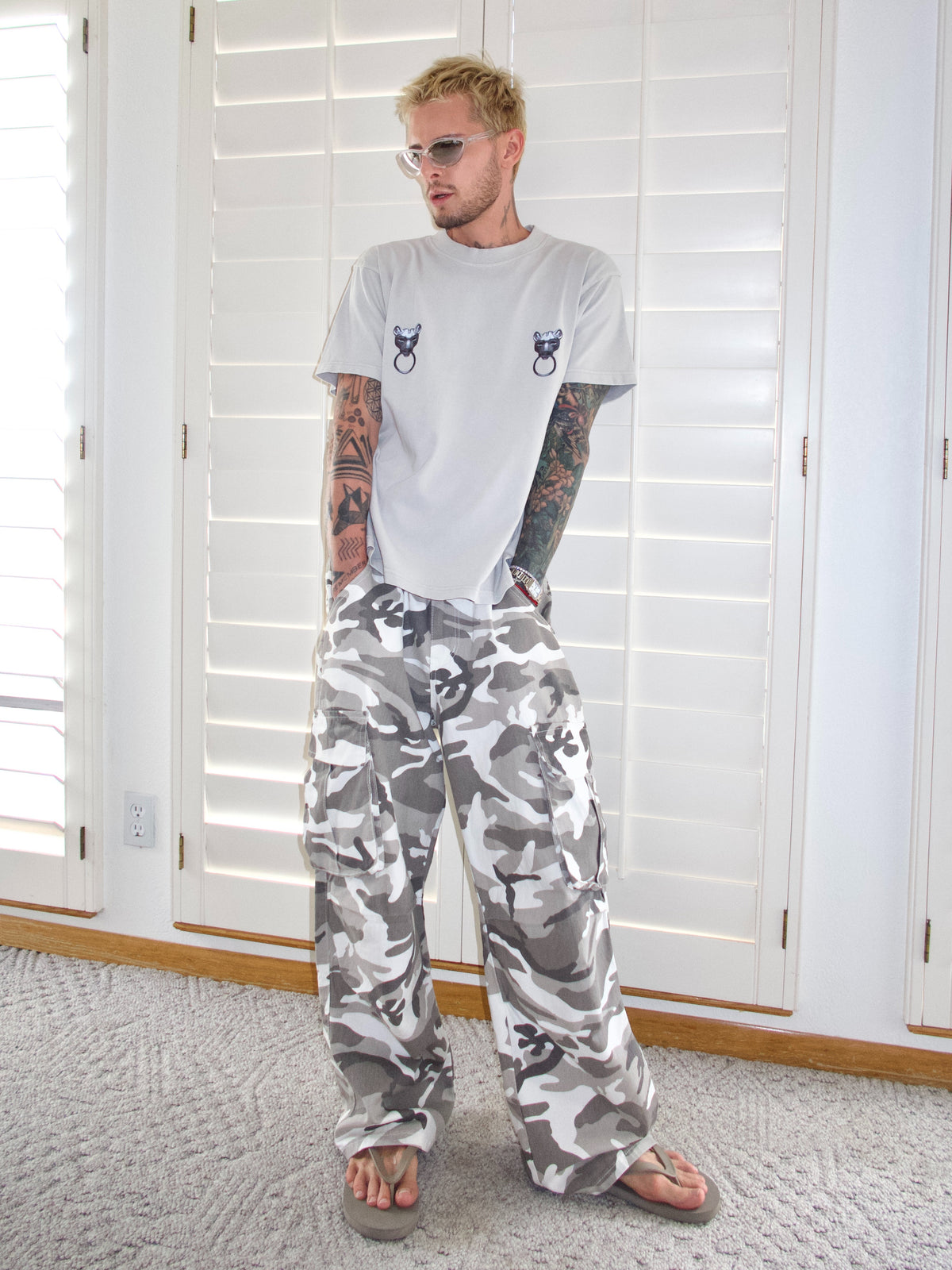 Light grey T-shirt with twin puma graphics and ring details across the chest, front view.