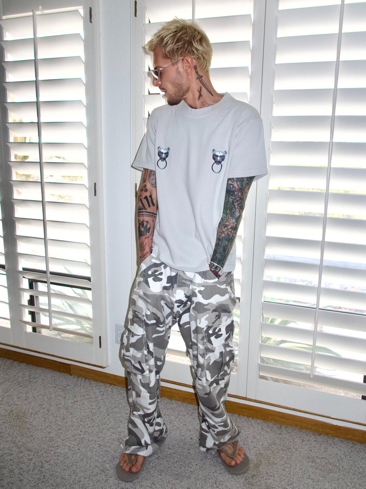 Light grey T-shirt with twin puma graphics and ring details, relaxed full-length view.