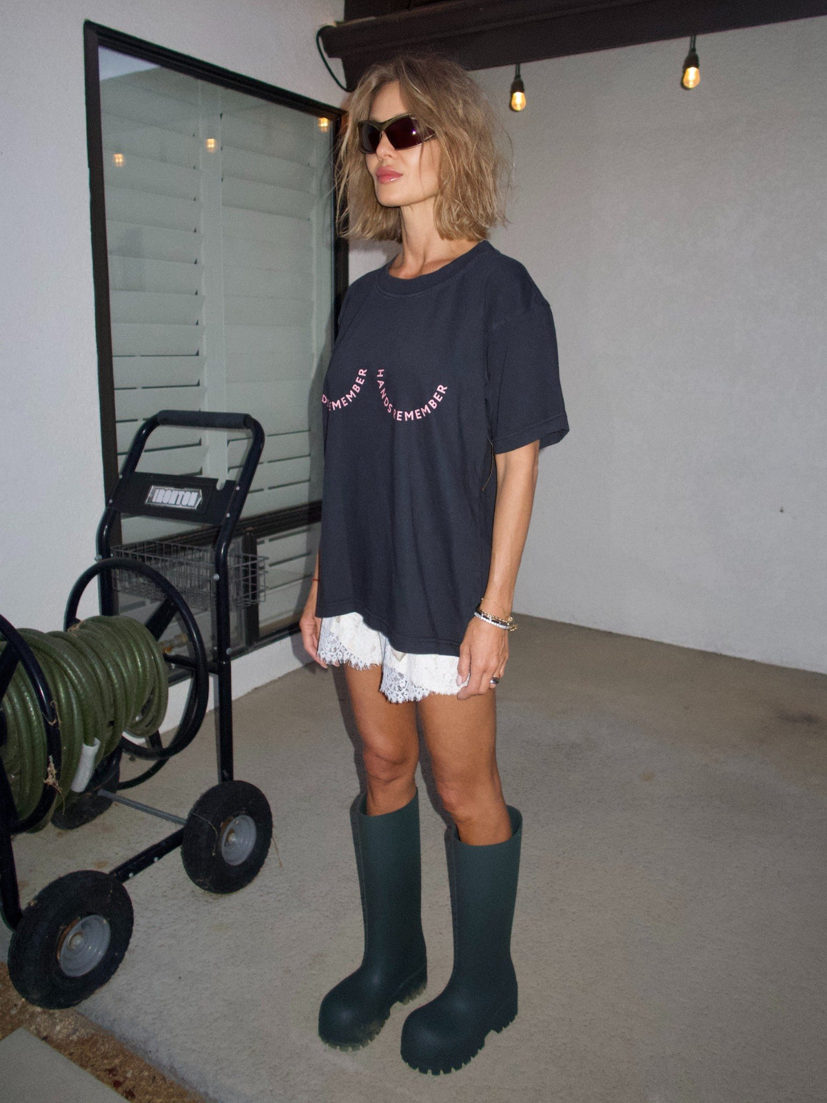 1. Black T-shirt with the “Hands Remember” graphic shaped across the chest, full-length front view.