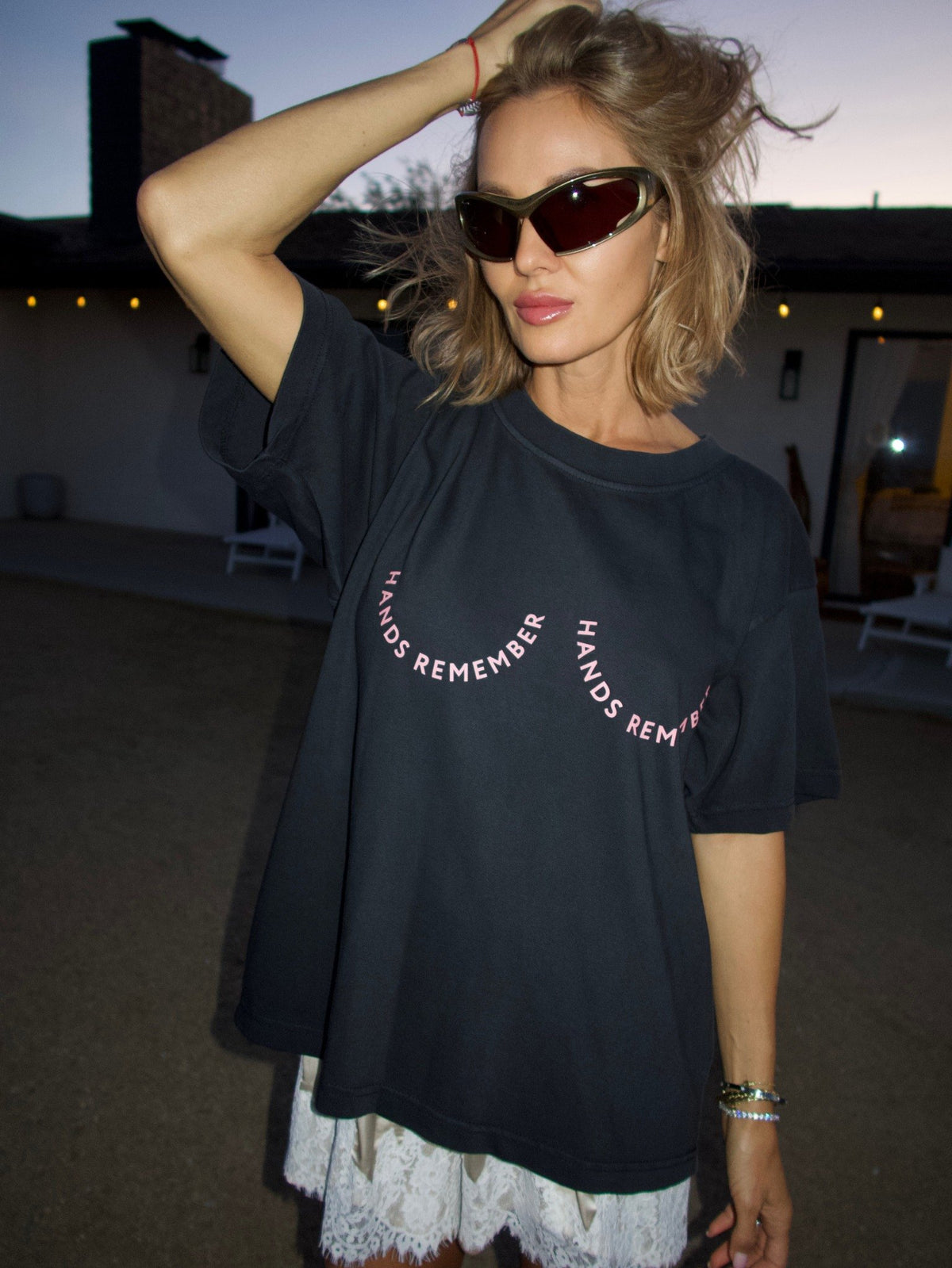 Black T-shirt with the “Hands Remember” graphic shaped across the chest, standing front view.