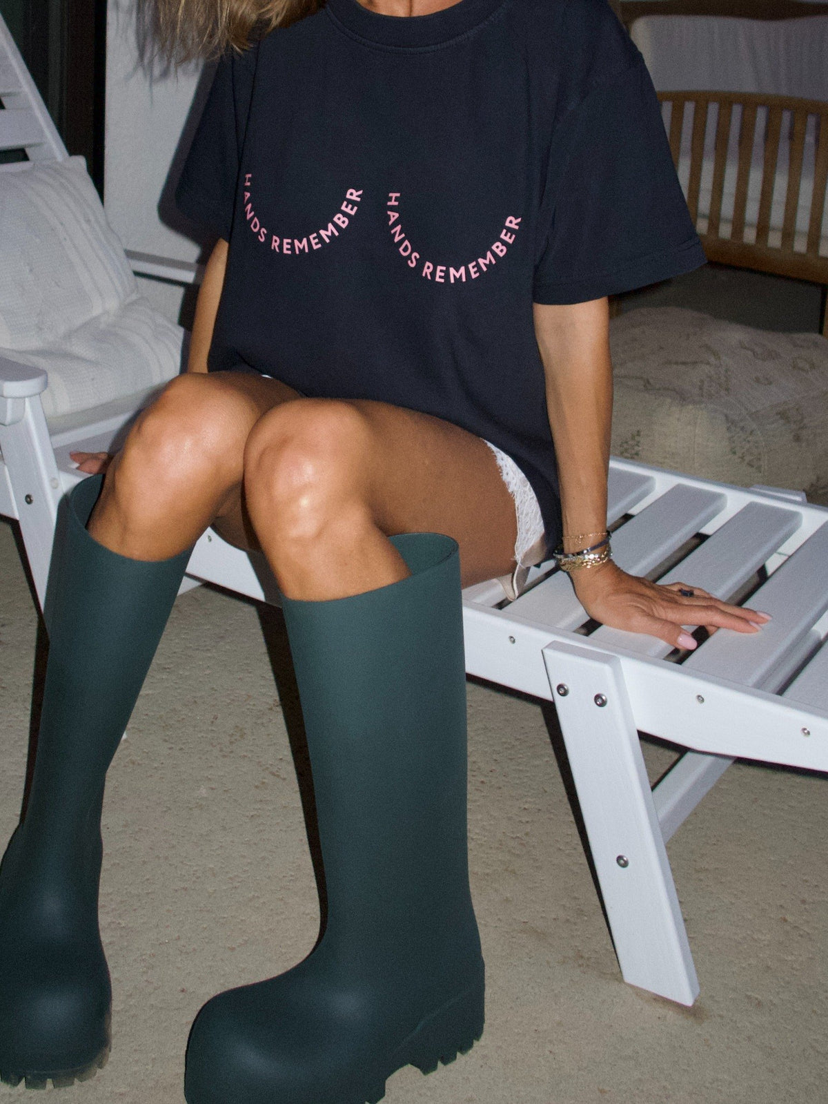 Black T-shirt with the “Hands Remember” graphic shaped across the chest, close-up front view.