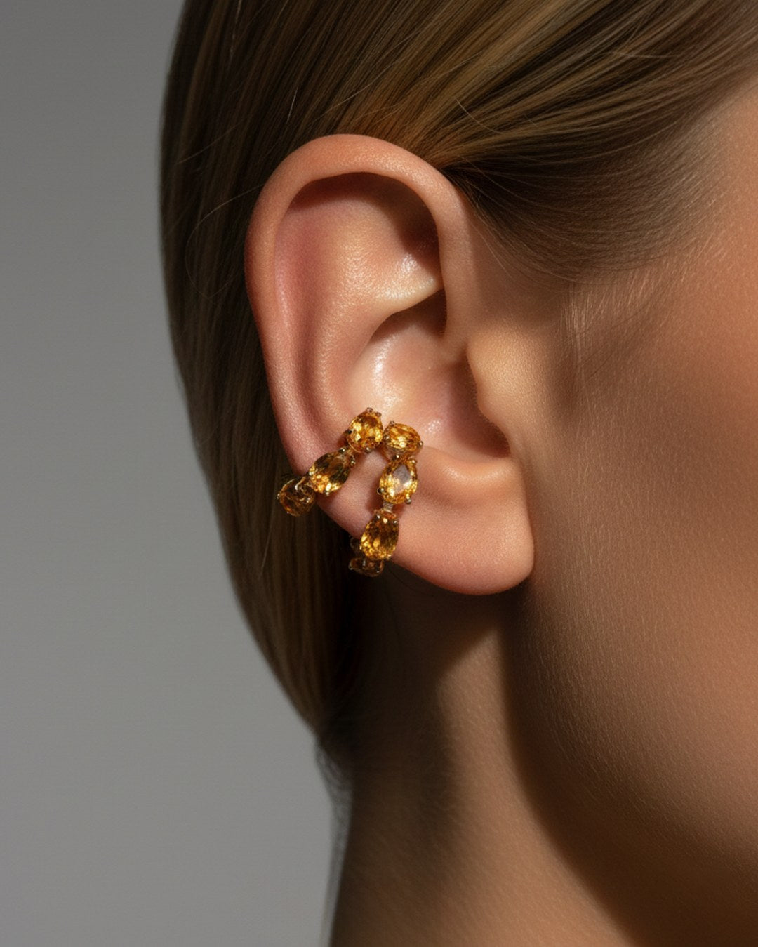 Minerals Maxi ear cuff with yellow citrines worn on the ear, front-side view.