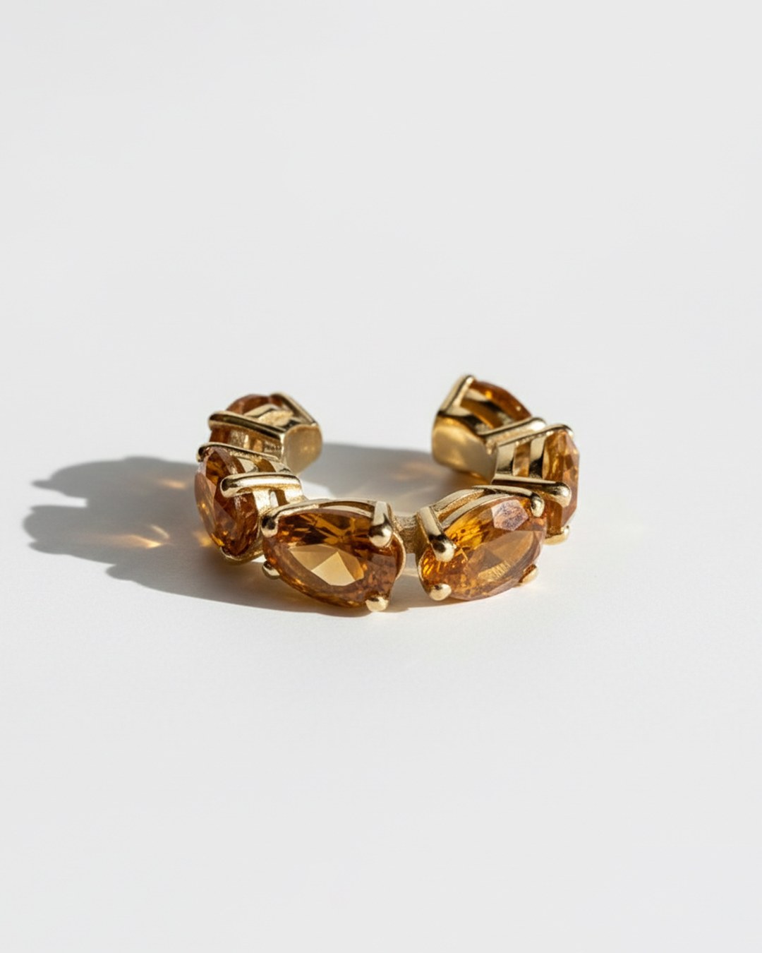 Minerals Mini ear cuff in gold-plated sterling silver with 6 pear-cut yellow citrines, angled front view.