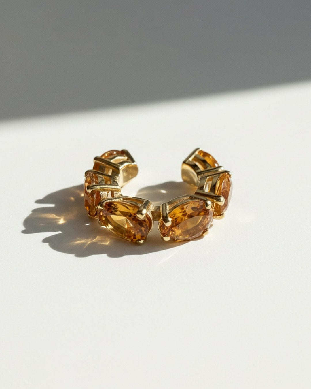 Minerals Mini ear cuff in gold-plated sterling silver with 6 pear-cut yellow citrines, angled product view.