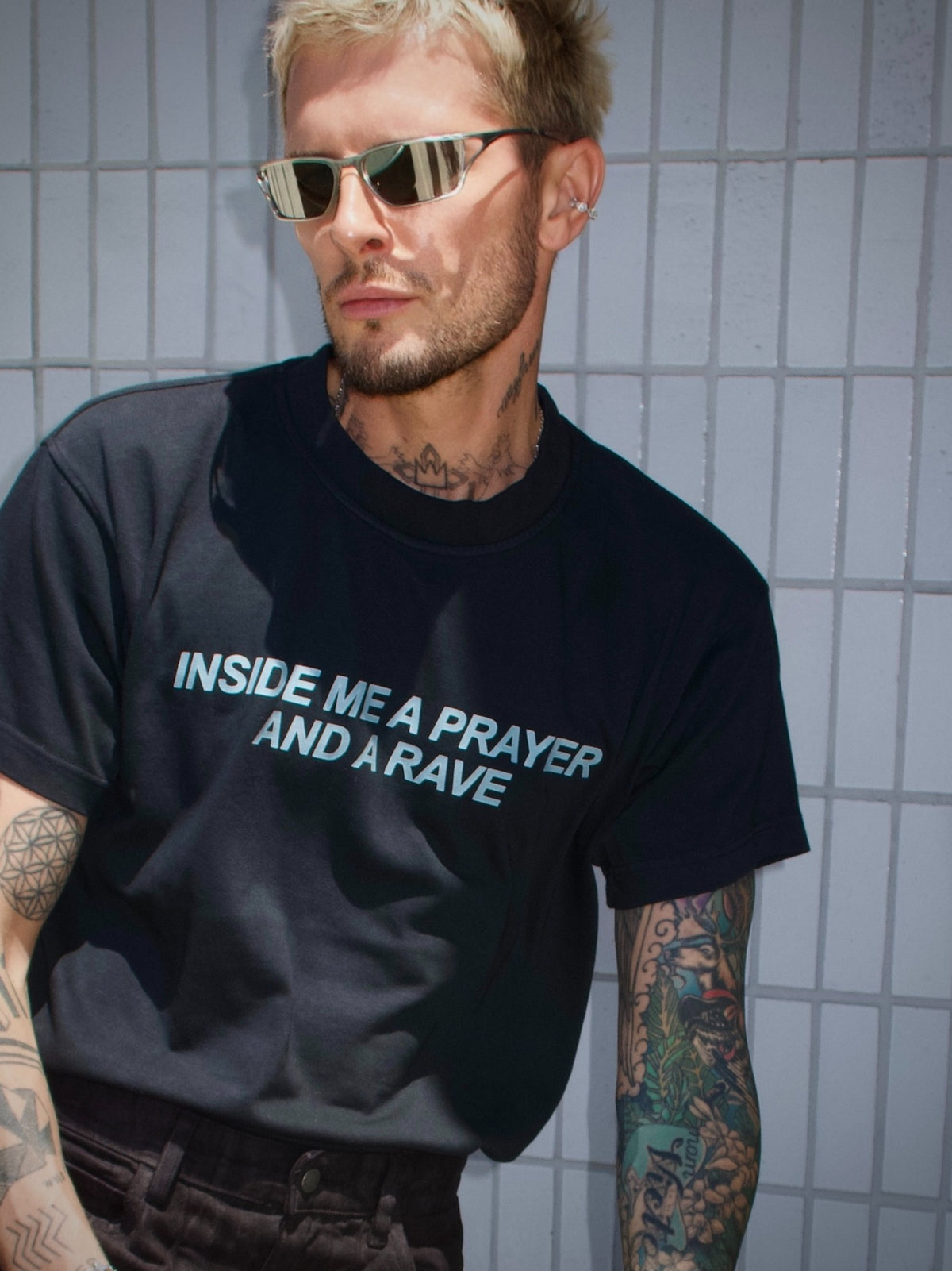 Black T-shirt with the “Inside Me a Prayer and a Rave” print, relaxed front view
